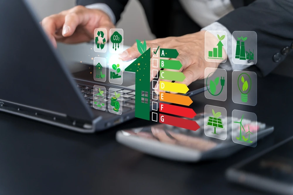Business professional reviewing sustainable building energy efficiency ratings on laptop.