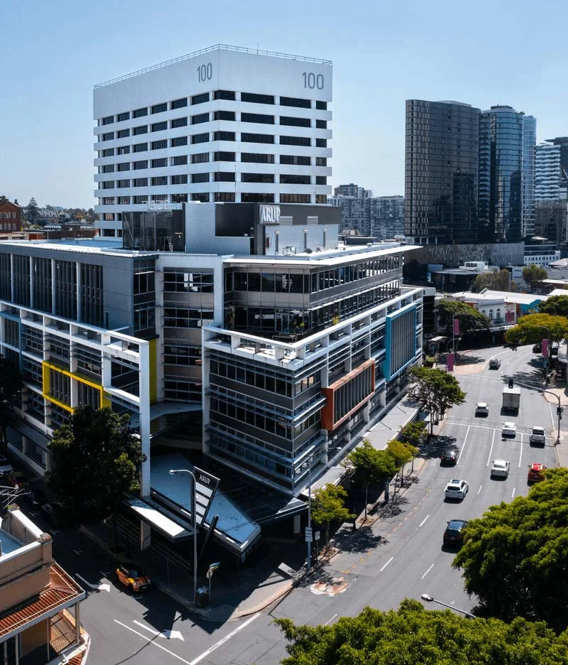 100 Wickham Street QLD commercial office tower with ARUP signage, modern facade and busy intersection